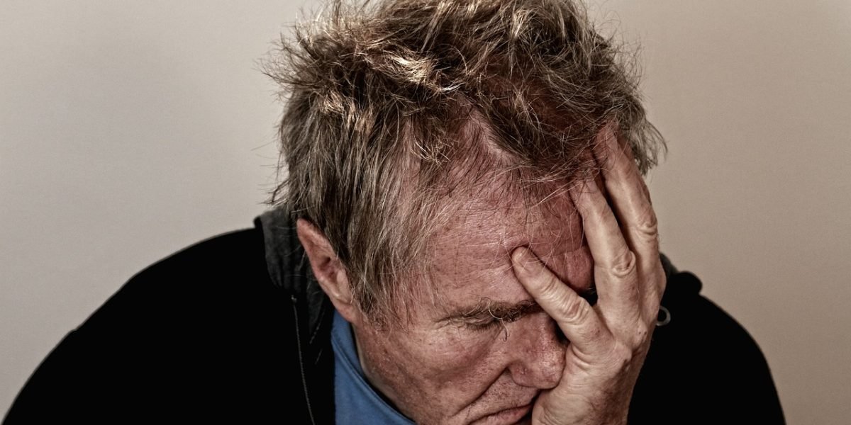 A person looks frustrated while browsing a website, symbolizing common poor UX experiences that lead to high bounce rates.