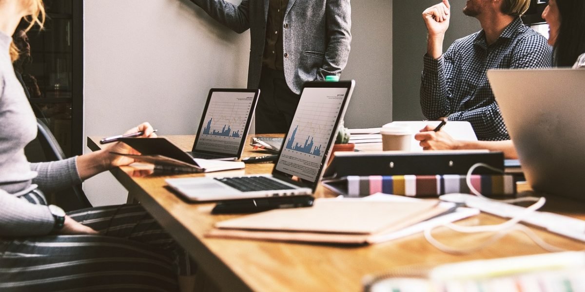 A business team reviews financial reports, emphasizing the importance of design decisions aligning with business outcomes.