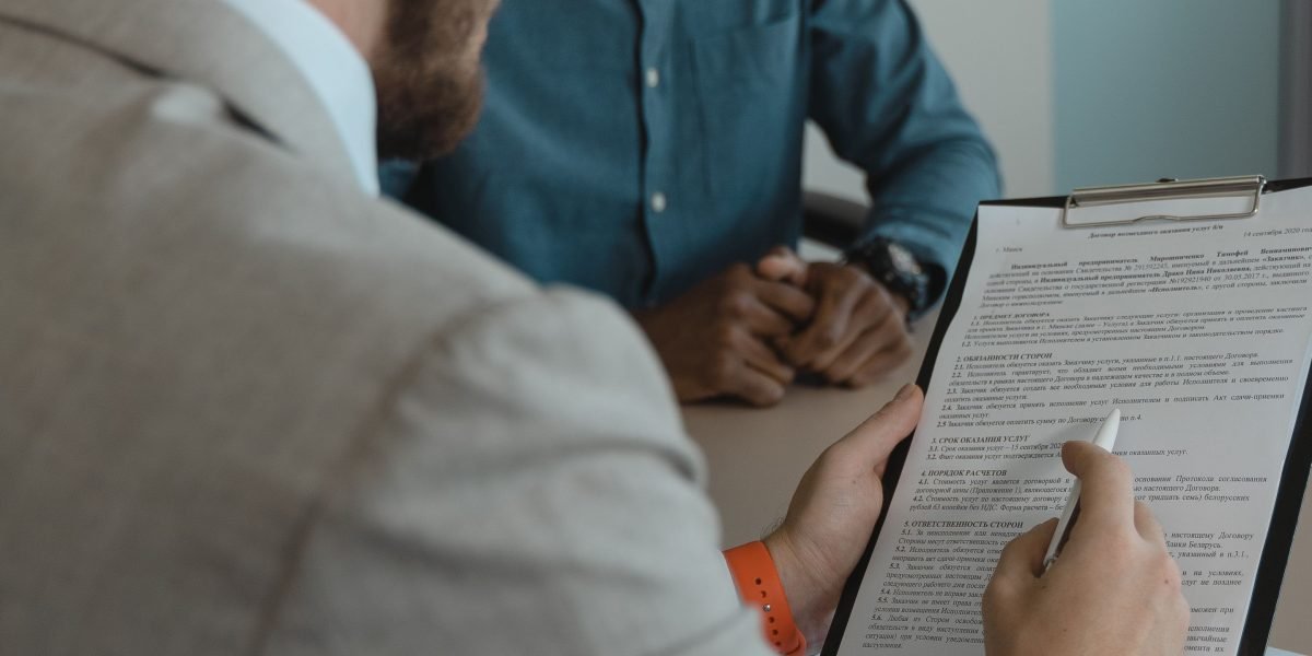 A hiring manager carefully reviews a design portfolio, looking for insights into the designer's thought process and impact.