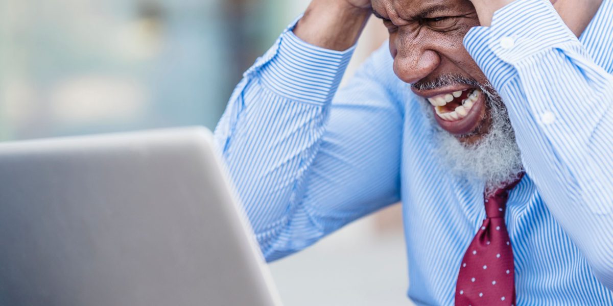 A business owner feeling frustrated while reviewing their website's performance.