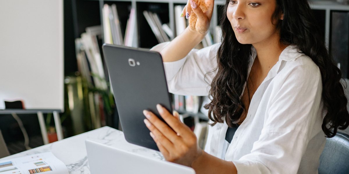 A person confidently interacting with a tablet, symbolizing a successful call-to-action leading to conversion.