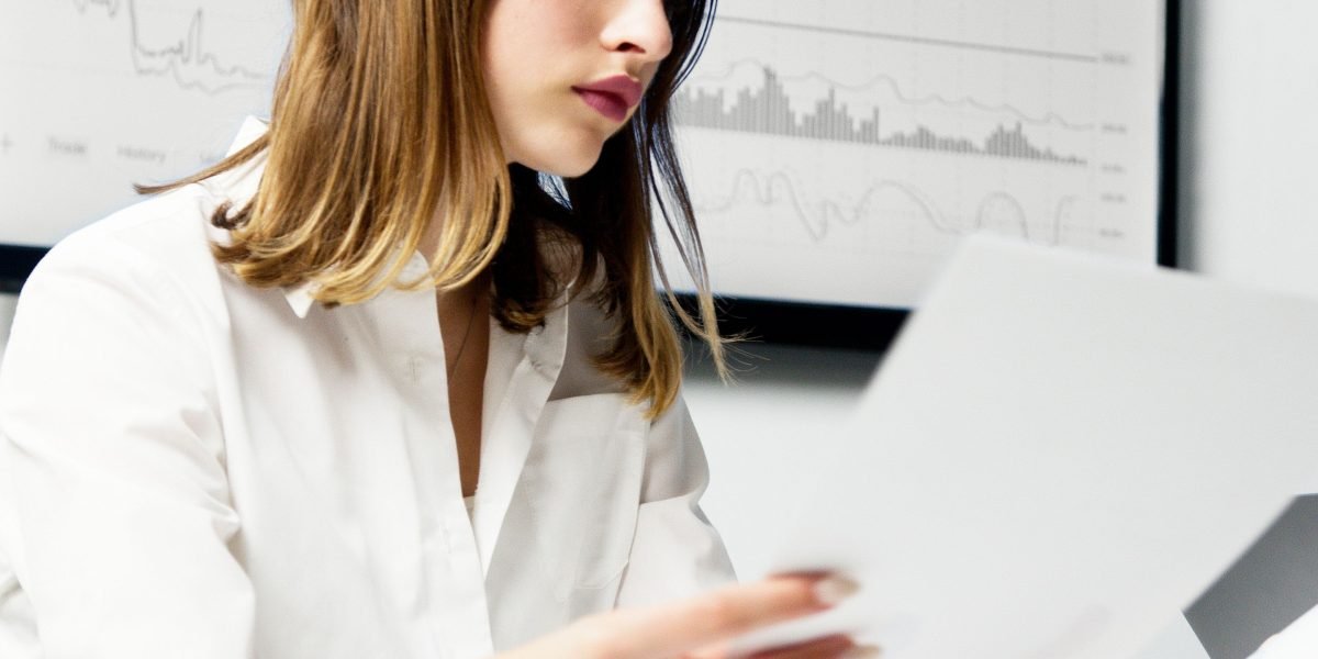 A person reviews financial documents, symbolizing the cost efficiency of SEO packages compared to in-house hires.