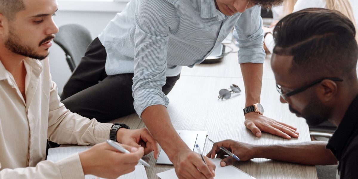A determined small business team collaborates, symbolizing their efforts to compete with larger brands.