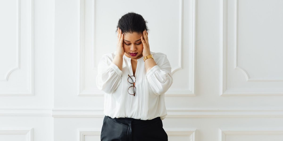 A business owner feeling overwhelmed by the complexities of hiring for design services.