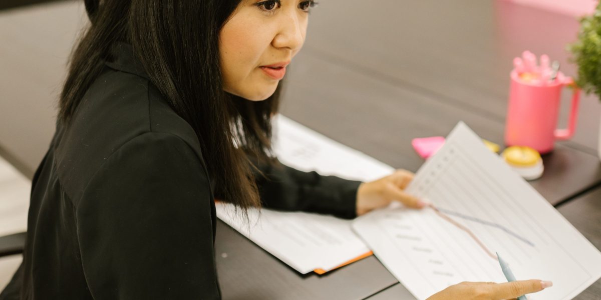 A business owner confidently reviewing well-structured design proposals.