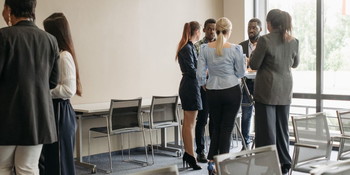 Business professionals engaging in a networking event, illustrating the source of photos for lead generation.