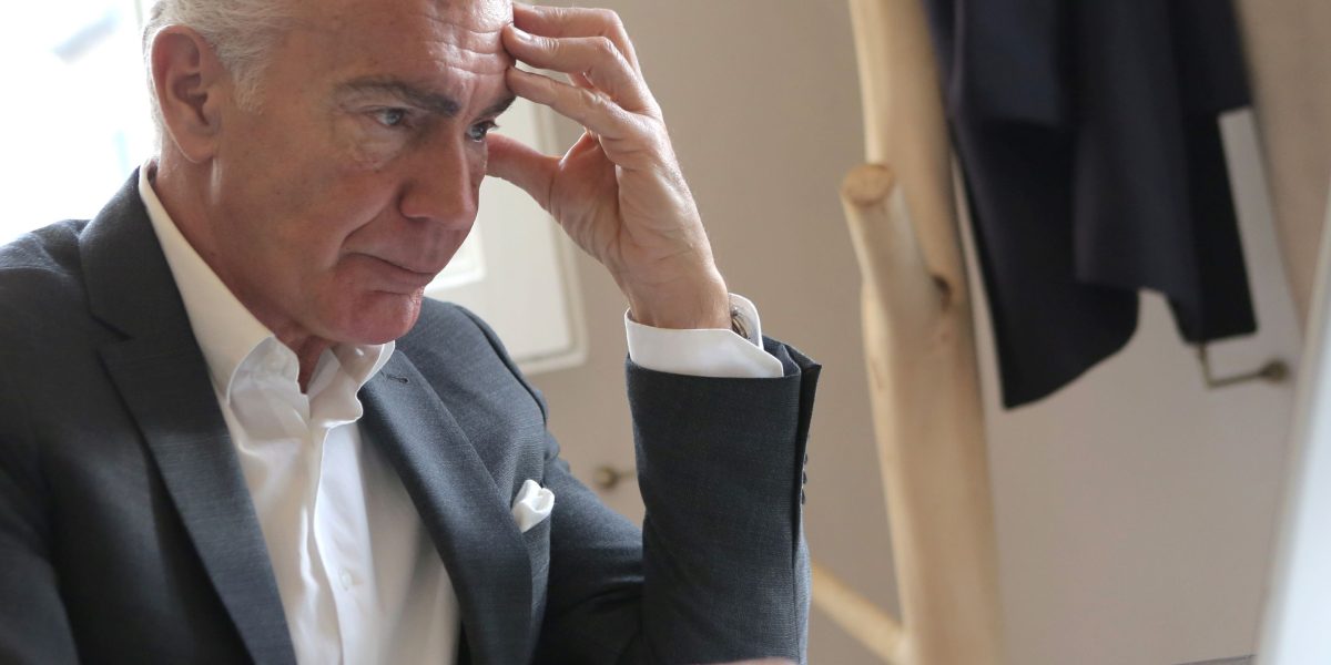 A business owner contemplating challenges in attracting qualified leads and achieving profitable growth.