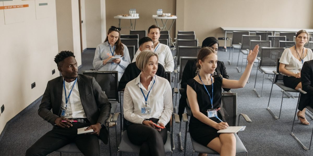 A professional asks questions during a meeting, representing the due diligence required when vetting a service provider.