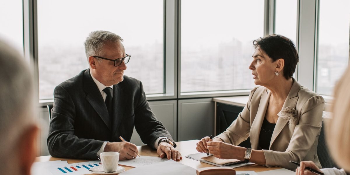 A diverse business team collaborating in a meeting, discussing strategy and competitive advantage in a dynamic market.