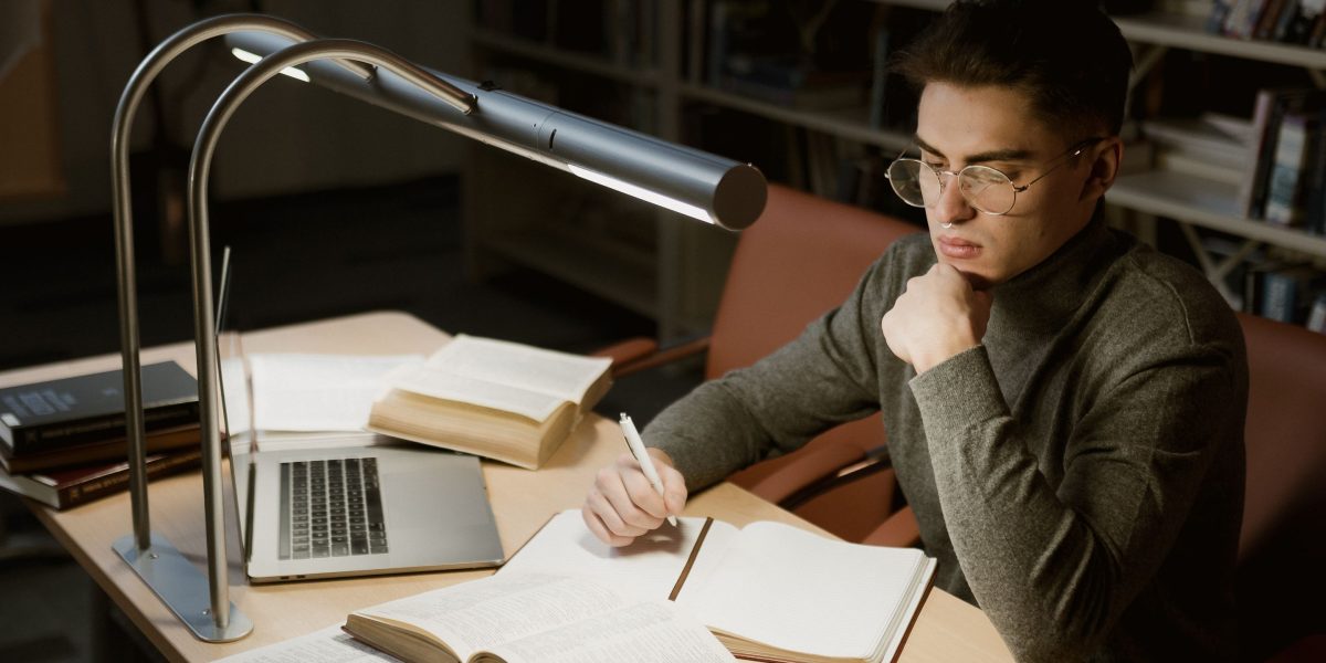 A person diligently researching and comparing various educational options on a laptop, mirroring the process of selecting a UI/UX course.