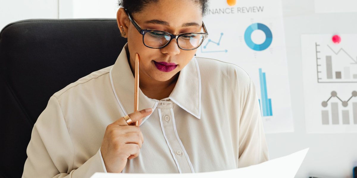 A business professional thoughtfully analyzing charts and graphs, representing data-driven decision making.