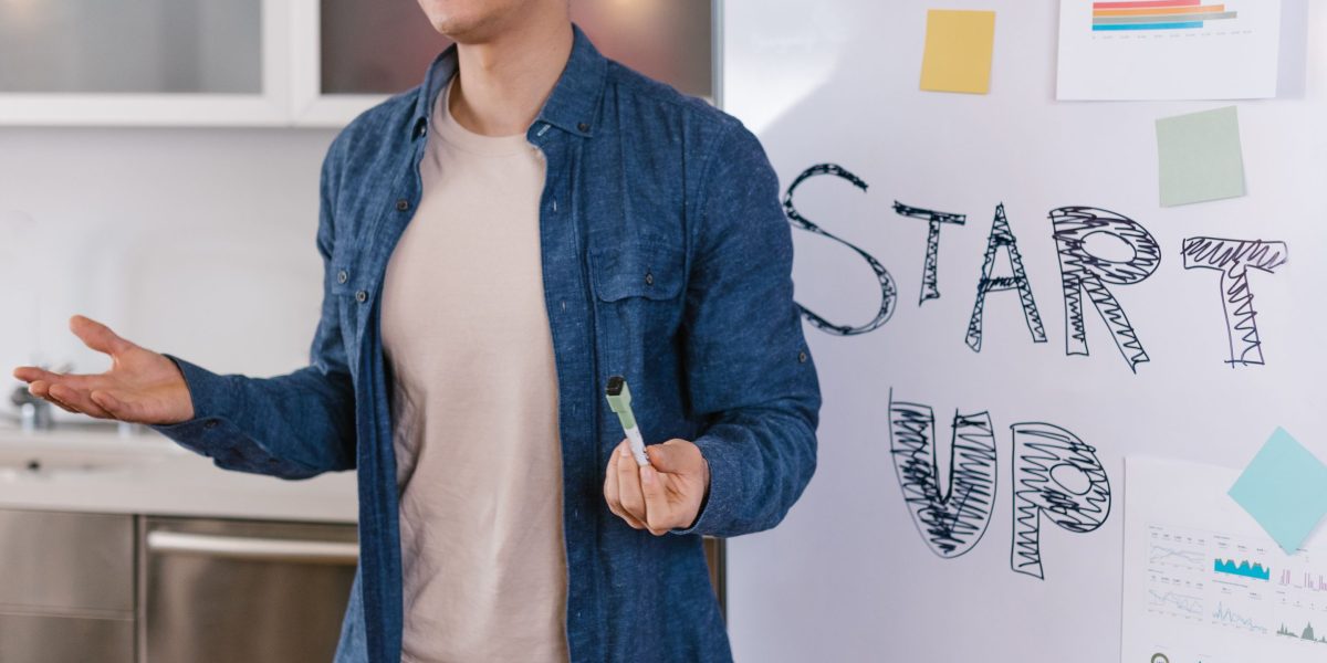 A small business owner sits at a desk, contemplating strategies for growth, reflecting on the challenges of running a business.