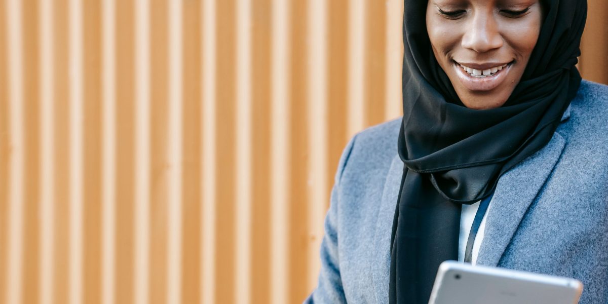 A person confidently uses a website on a tablet, experiencing smooth and enjoyable navigation, symbolizing good UX design.