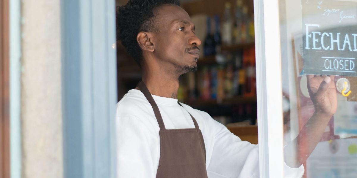 A small business owner thoughtfully considering strategies to overcome online growth challenges.