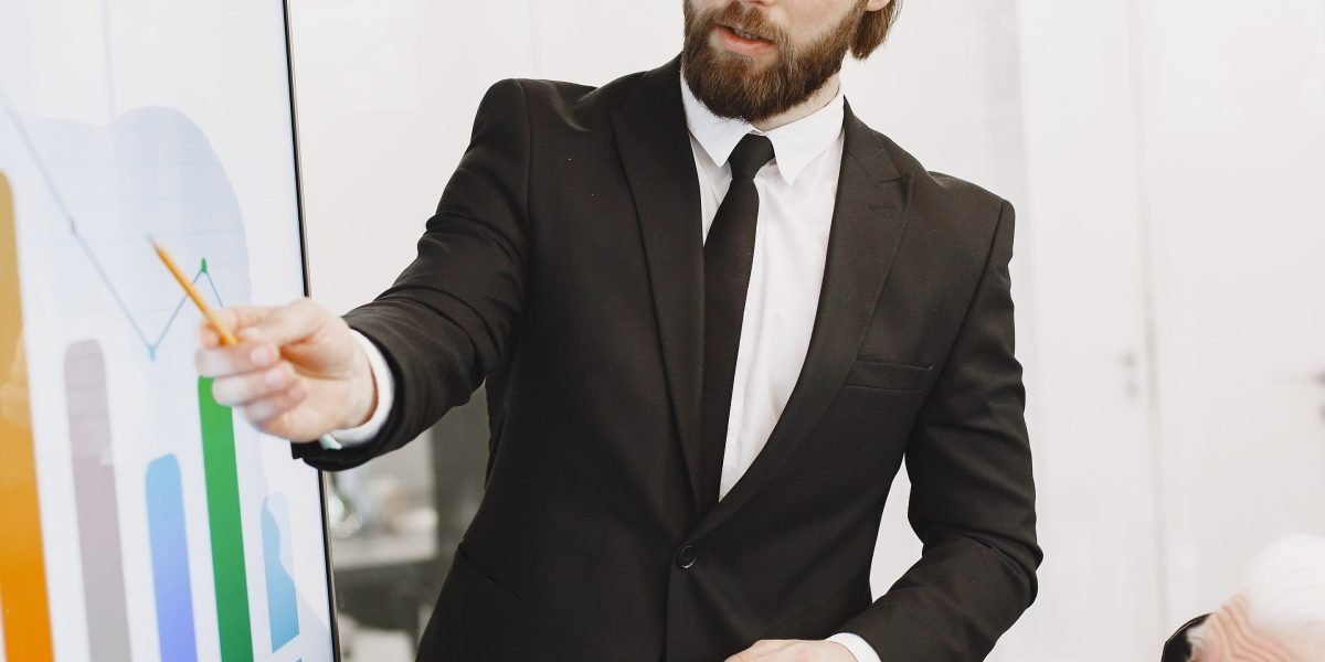 A confident professional presenting a detailed business growth plan to a small group of stakeholders.