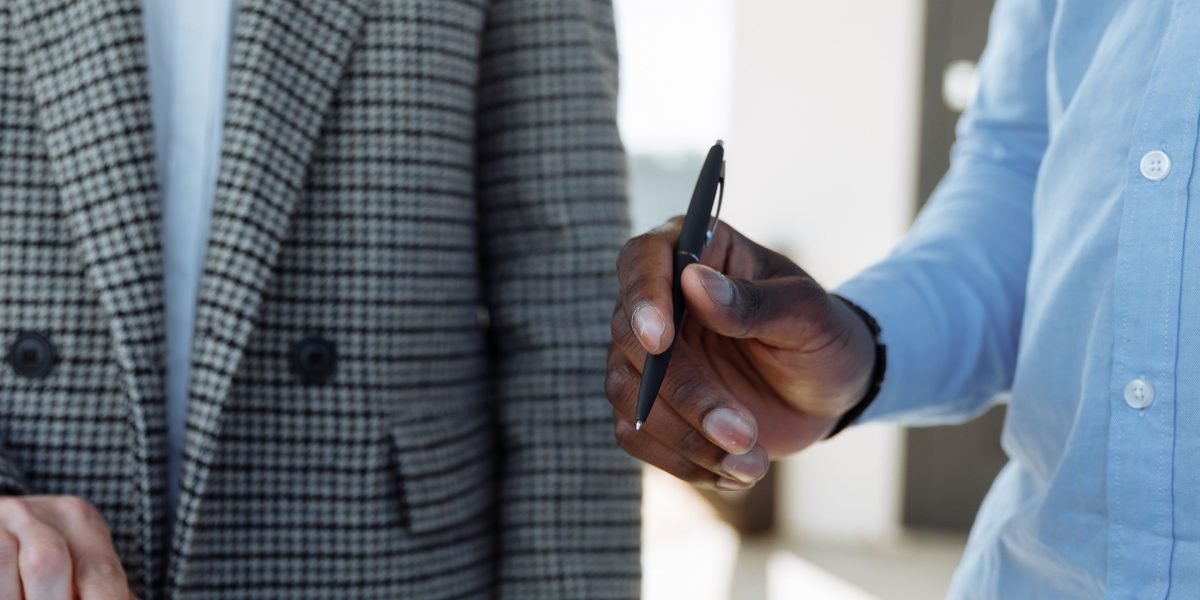 Business owners carefully reviewing the terms and conditions of a contract to ensure transparency and understanding.
