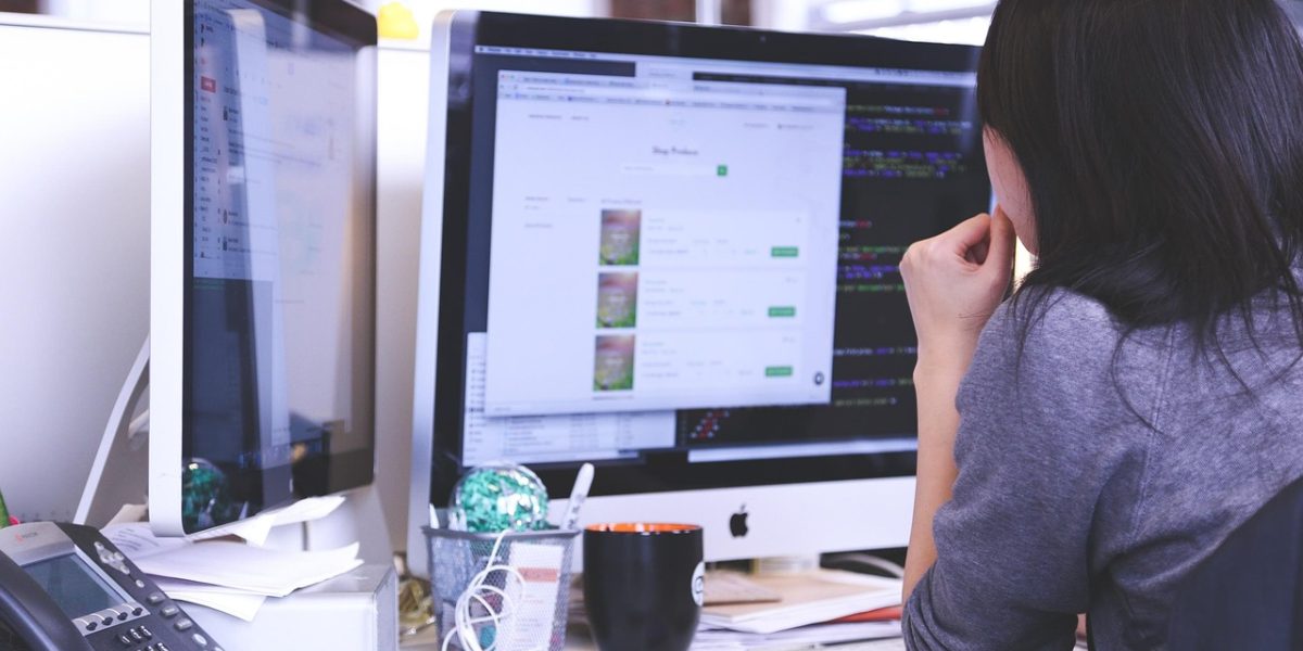 A small business owner reviewing a checklist or plan, focusing on improving their online store.