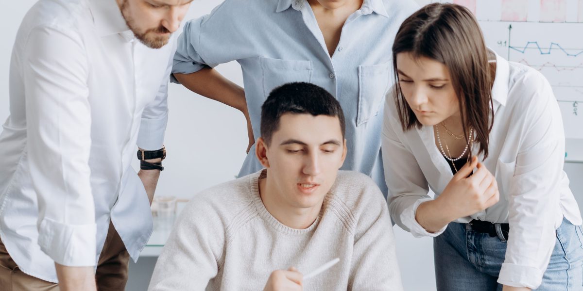 A team collaborates in an office, brainstorming and strategizing their marketing plan, including affiliate partnerships.