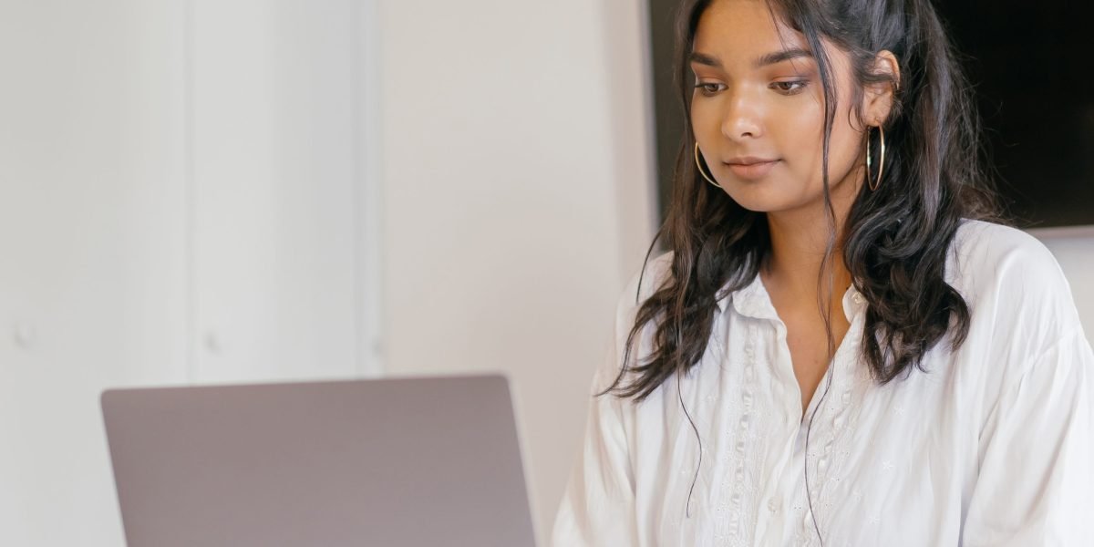 An individual actively engaging in an online marketing class, gaining new skills to empower their business.