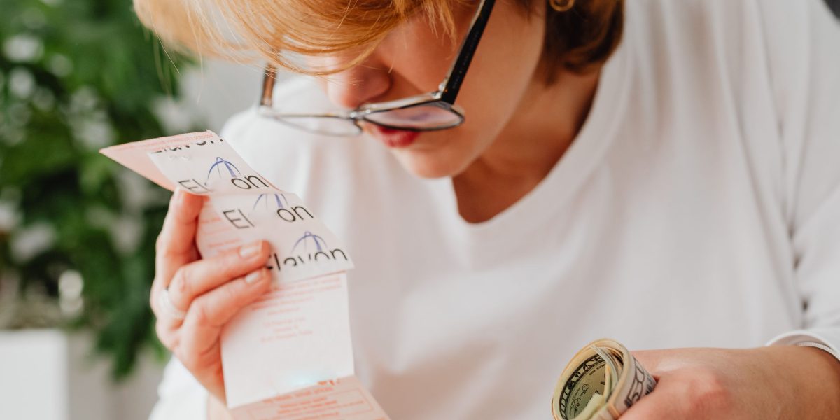 A small business owner meticulously reviewing financial reports to allocate marketing budget effectively.
