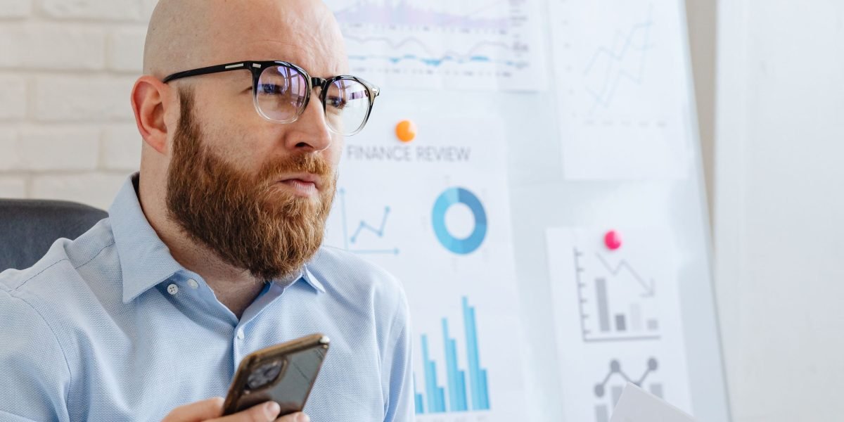 A small business owner deeply focused on strategy for business growth, contemplating new opportunities.