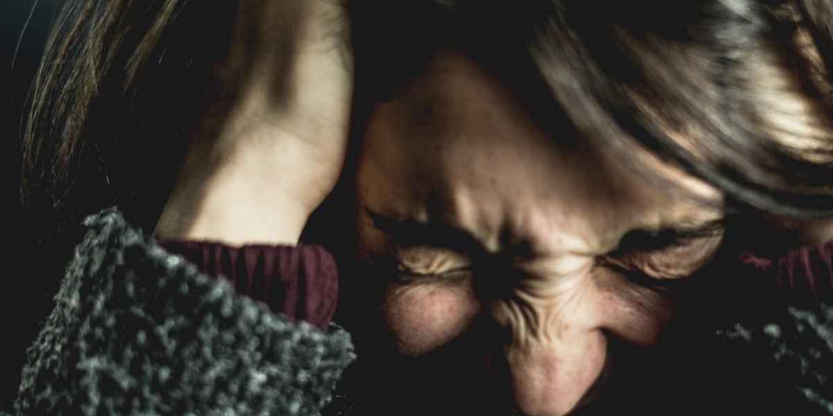 A person looking frustrated, perhaps struggling with a website or an online task due to poor design.