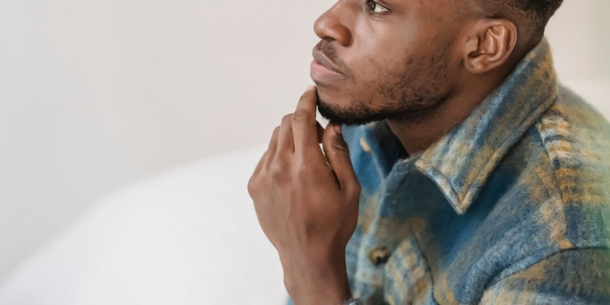 A person focused on a screen, thoughtfully considering a call-to-action, illustrating the moment of conversion on a well-designed page.