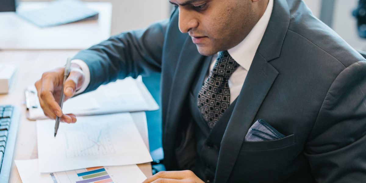 A person focused on analyzing business reports, symbolizing the initial audit phase of a website redesign.