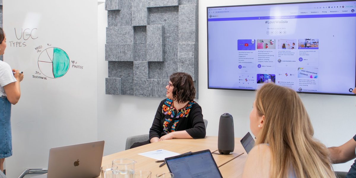 A diverse team collaborating to discuss user feedback and improve the overall user experience of a digital product.