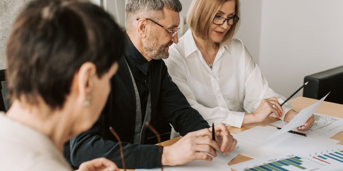 A team of professionals collaborating on a strategy, symbolizing the integration of paid and organic marketing efforts.