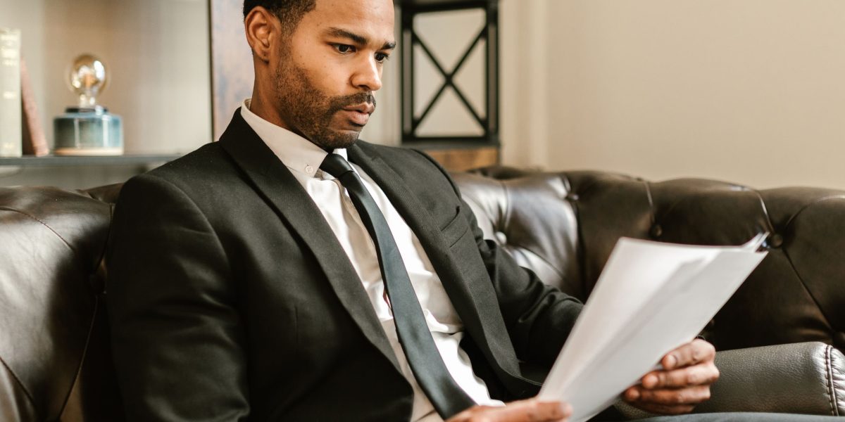 A person carefully reviewing documents, representing the meticulous process of optimizing product listings and content for better conversion.
