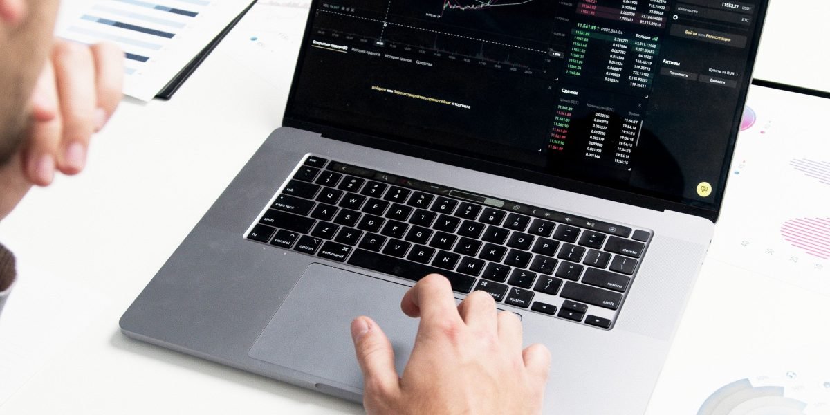 A professional analyzing charts and figures on a large screen, reflecting the importance of measuring performance and KPIs for business scaling.