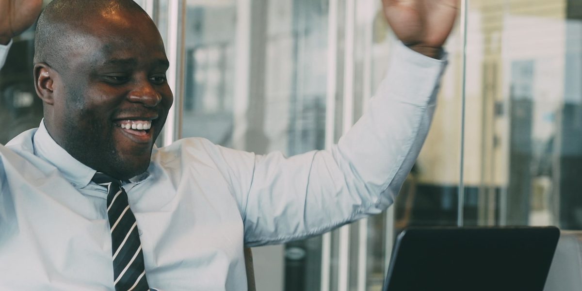 A person expressing joy and confidence after successfully achieving their professional objectives.