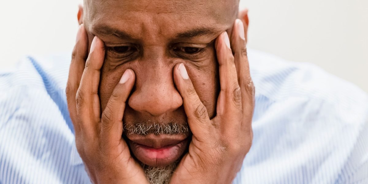 A small business owner looks thoughtfully at a laptop, pondering their website's performance.