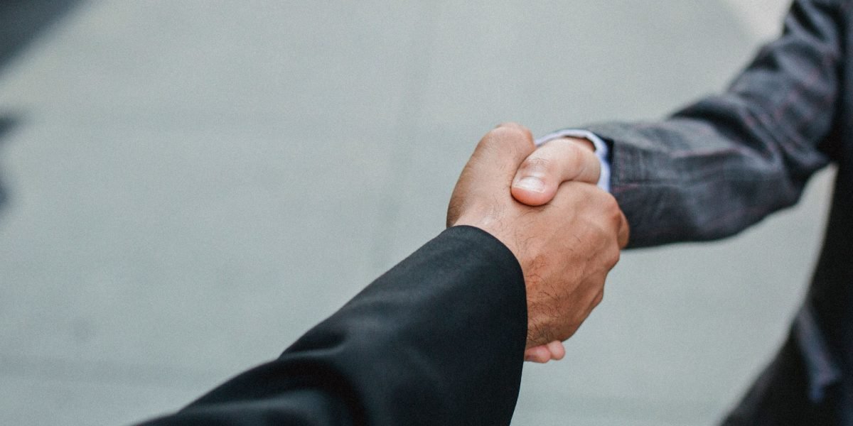 Professionals shaking hands, symbolizing the start of a new business partnership with an SEO agency.