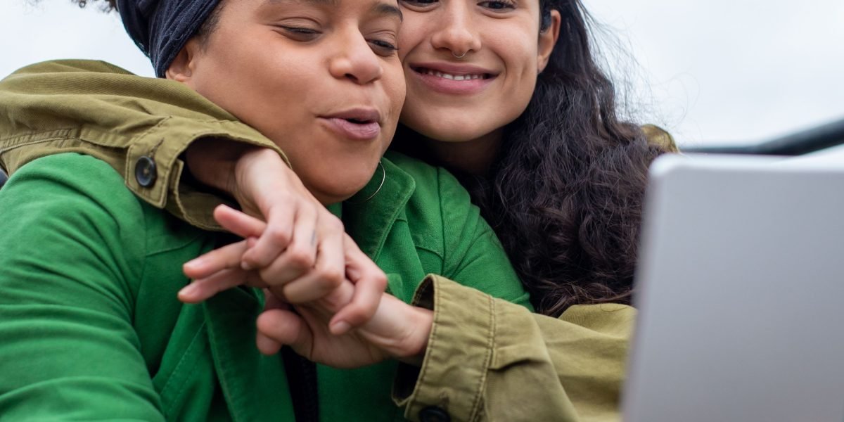 Diverse individuals easily interacting with digital content on a tablet, highlighting accessibility benefits.