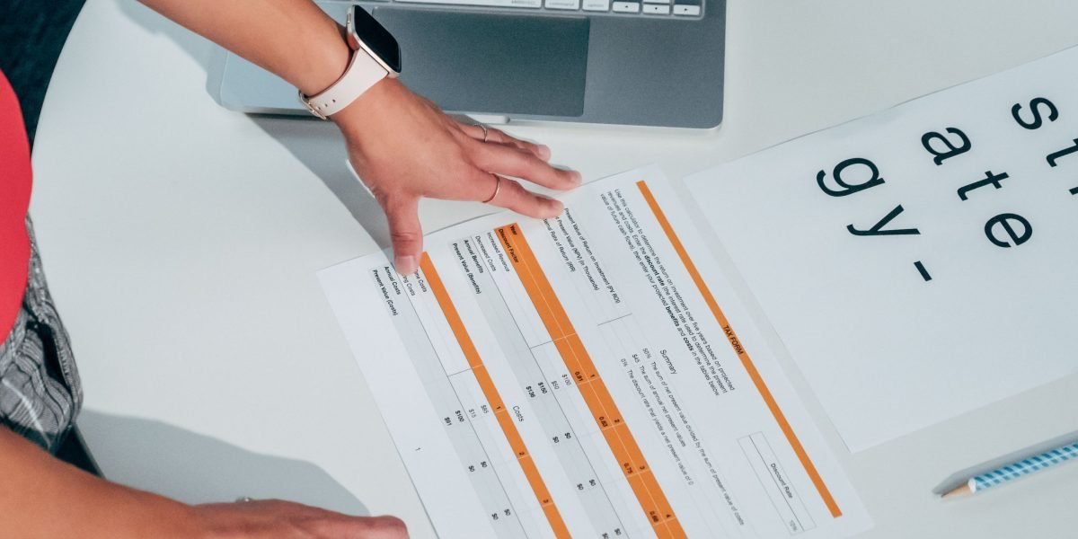 A professional meticulously reviewing documents, representing the careful evaluation of course quality and outcomes.