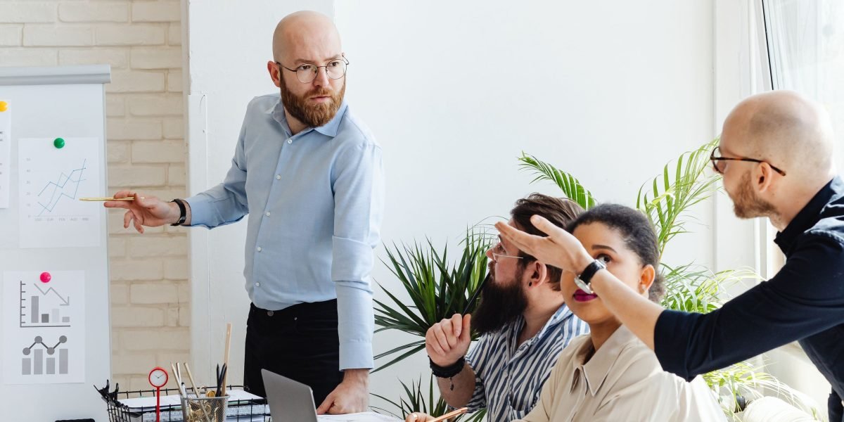 A designer confidently presenting their work to a team, embodying the culmination of portfolio building and freelance success.