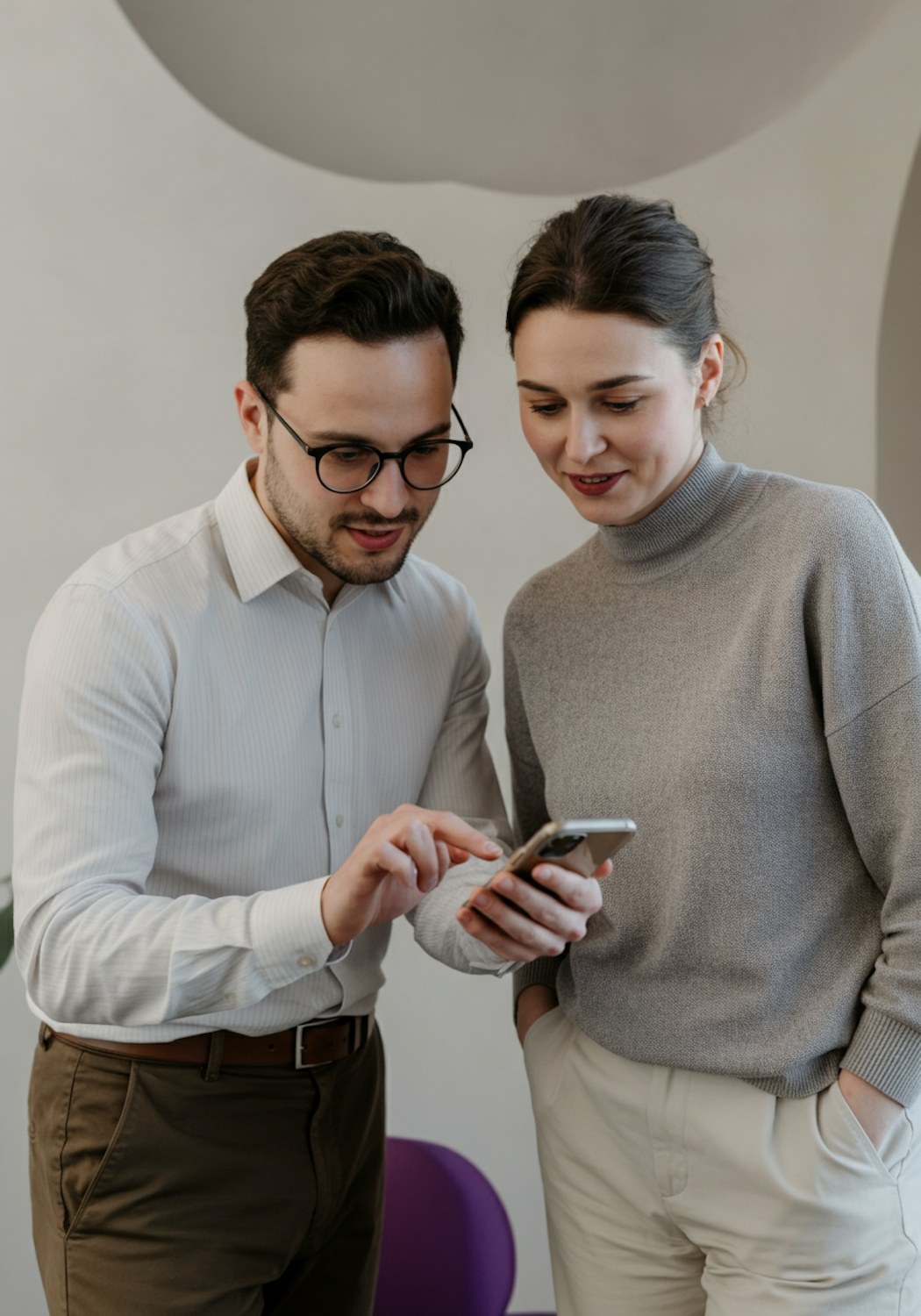 A person intently using a smartphone, simulating user experience testing of a mobile website or application.