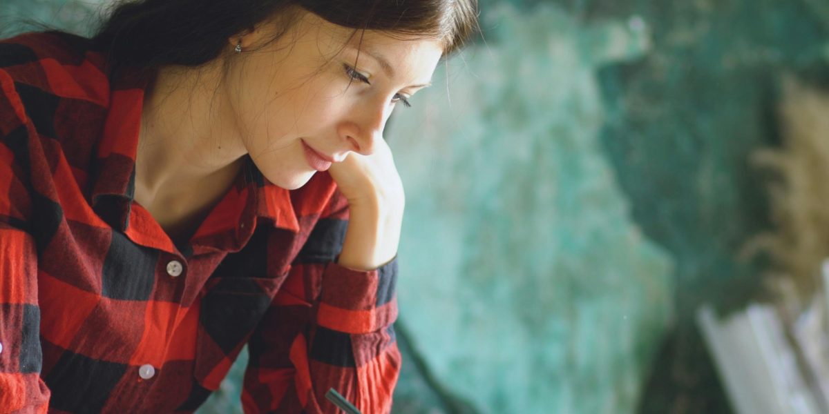 An individual deeply focused on a creative design project, reflecting hands-on learning.