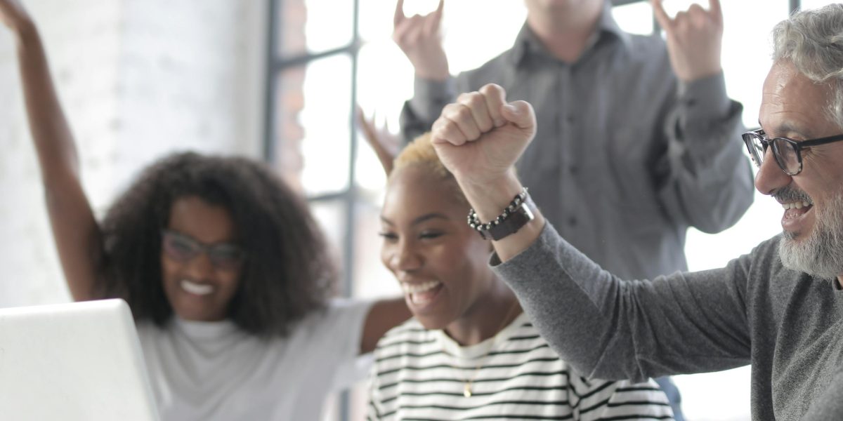 A team celebrates reaching their goals, reflecting the positive outcomes of effective SEO strategies.