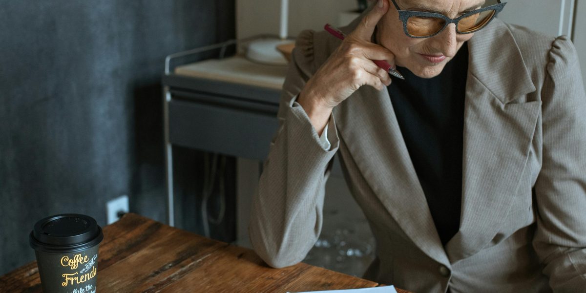 A small business owner thoughtfully reviews design concepts, embodying the aspiration for professional visuals for their brand.