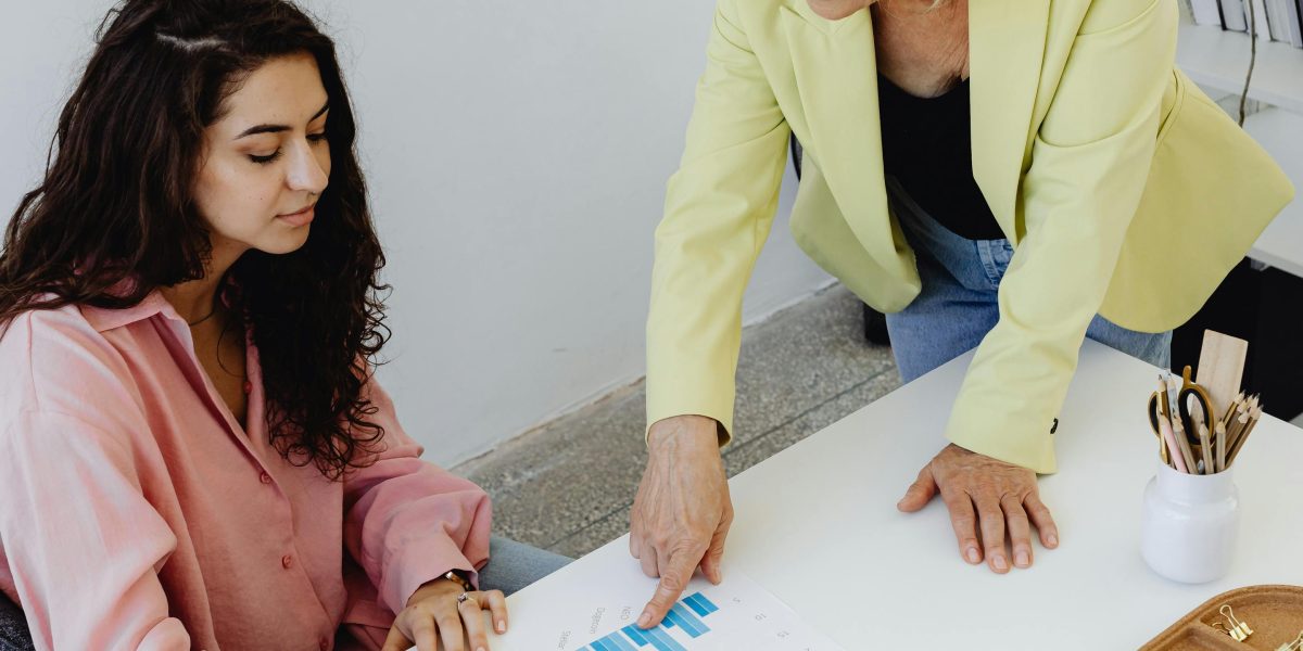 An experienced professional provides guidance and constructive feedback to a younger team member, fostering growth and learning.