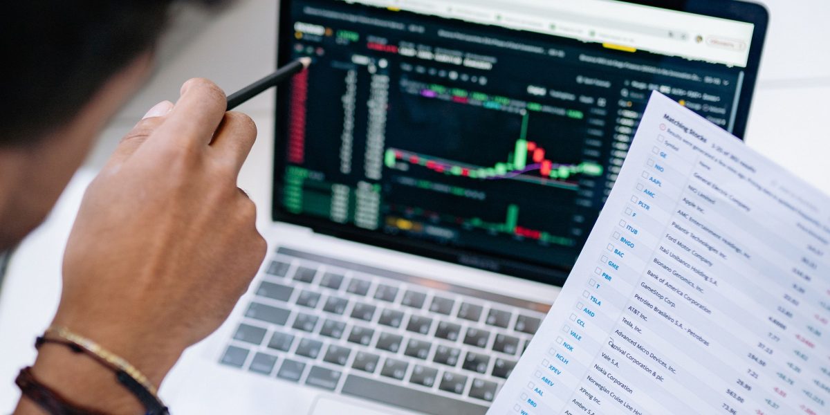 A person reviewing charts and data, symbolizing the process of measuring success and optimizing performance.