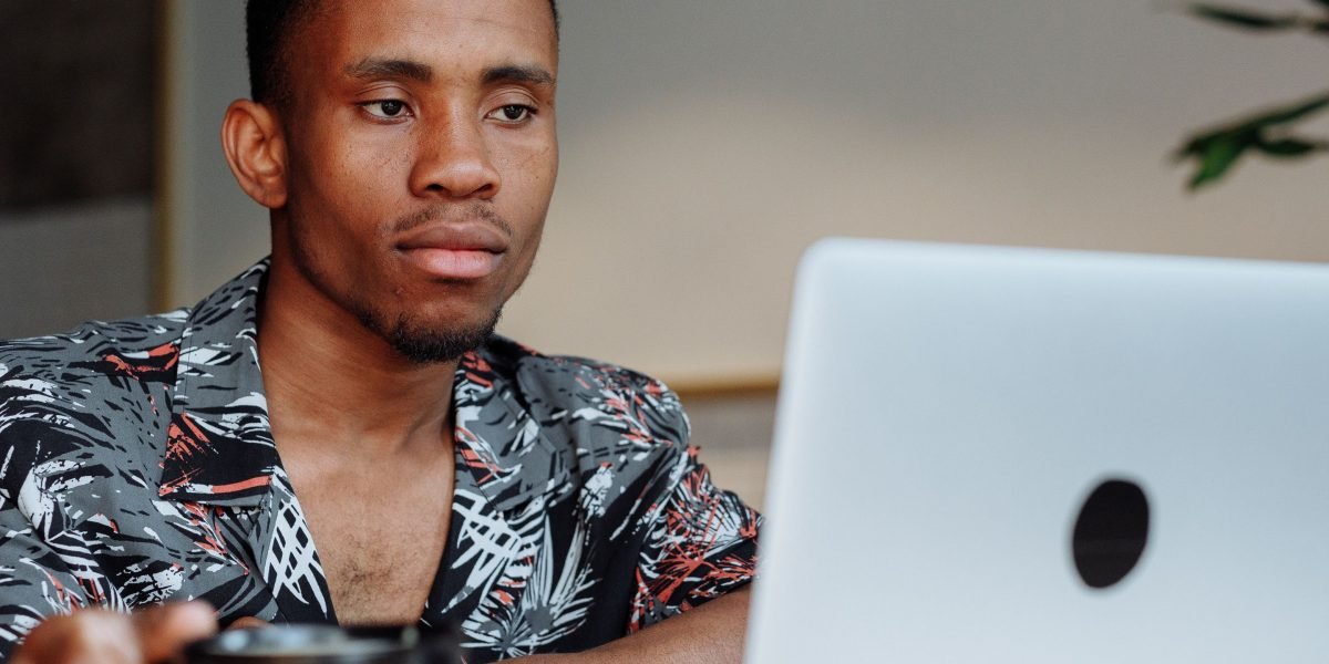 A small business owner thoughtfully researching online solutions.